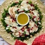 Pear salad on gold platter with red bow.
