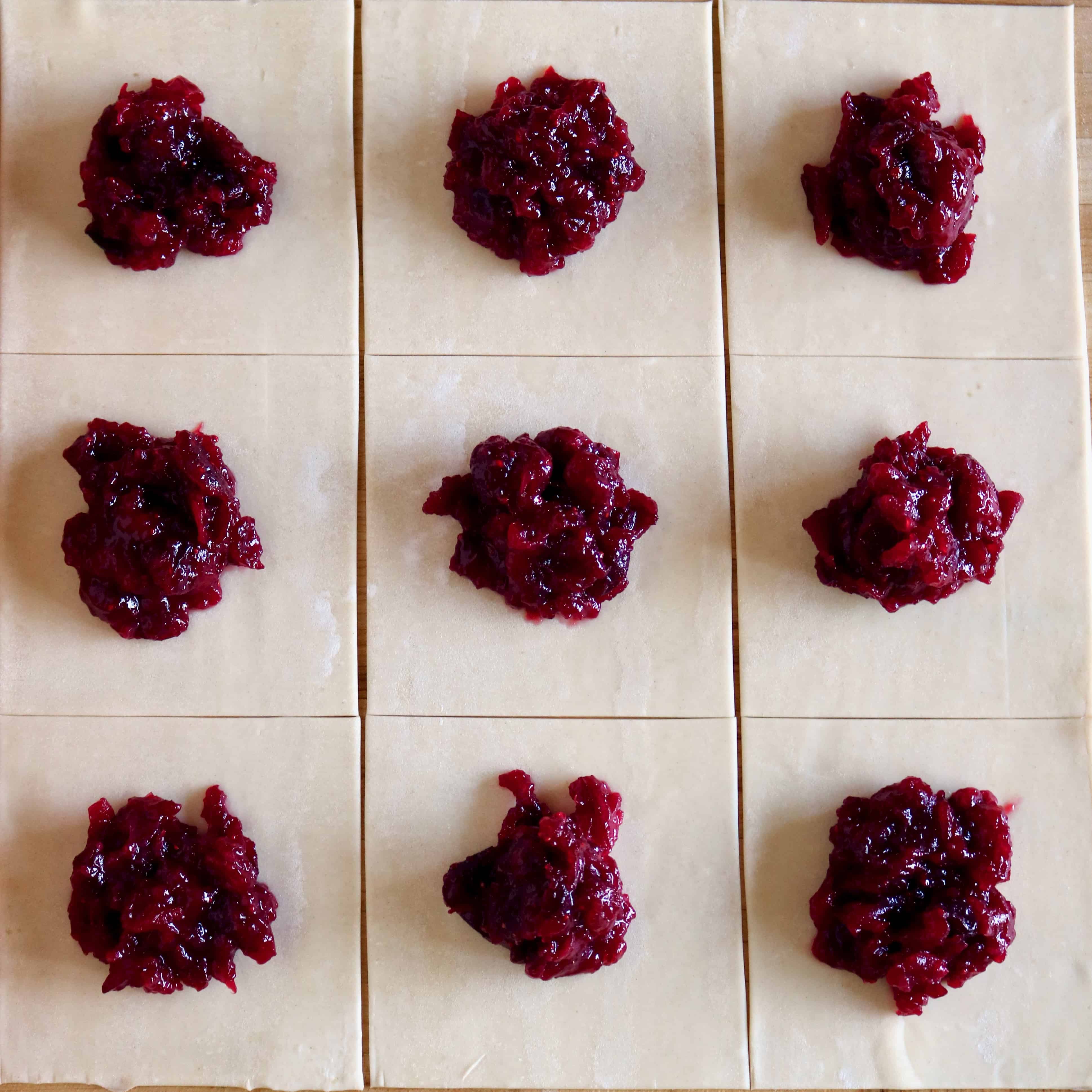 Pastry squares topped with cranberry filling.