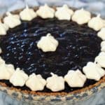 wild berry pie topped with meringue stars sitting on counter