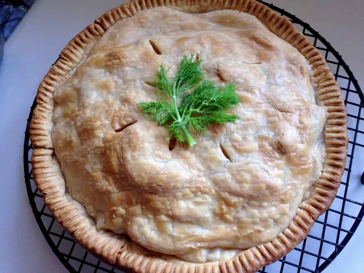 Baked fennel apple pie on cooling rack.