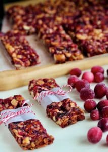 Wrapped cranberry crunch bars with fresh cranberries.