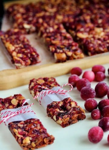 Wrapped cranberry crunch bars with fresh cranberries.