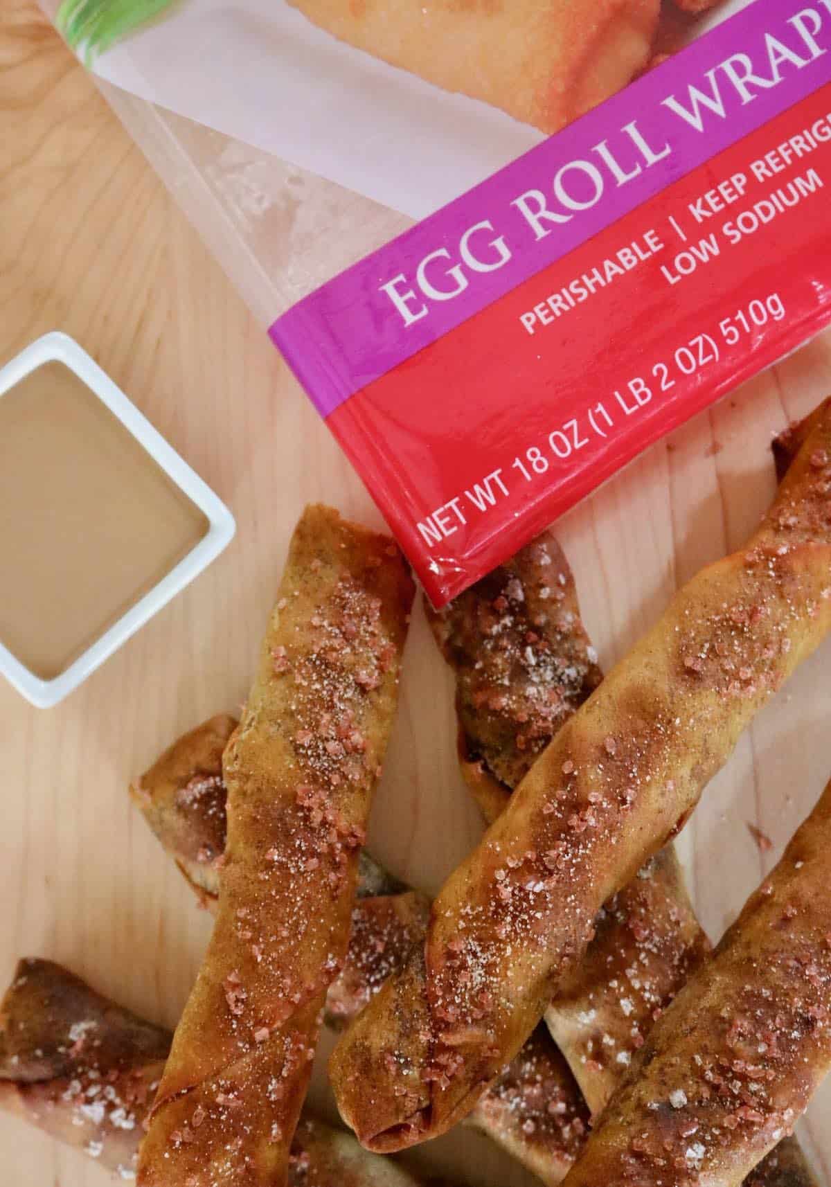 Egg roll pretzel sticks with caramel and product package.