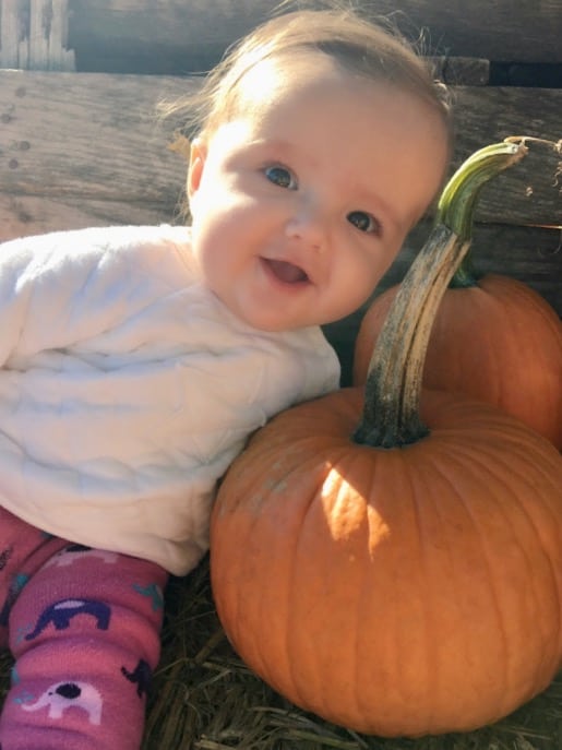 My granddaughter with a pumpkin.