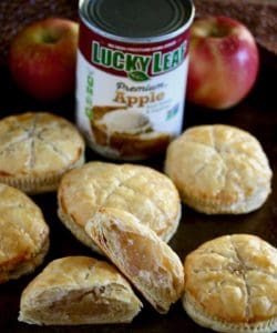 Apple filled pastries with fresh apples and product can.