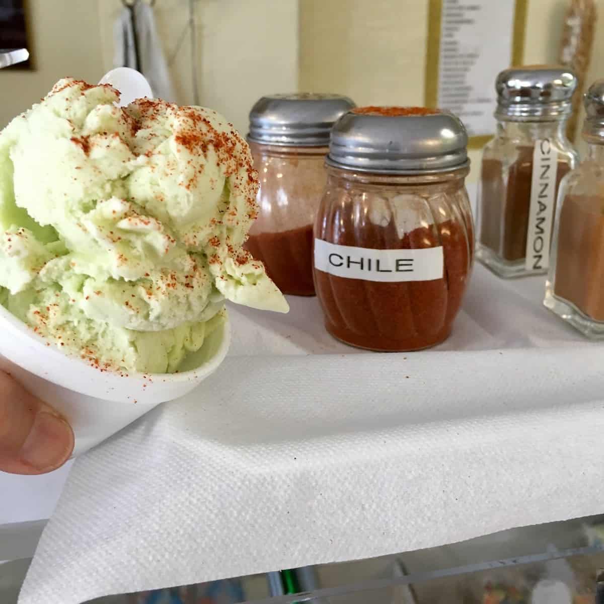 At the ice cream parlor with avocado ice cream topped with chili powder.