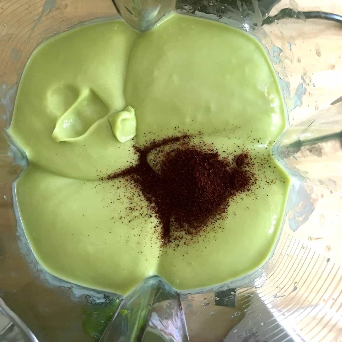 Avocado and chili powder swirled in blender.