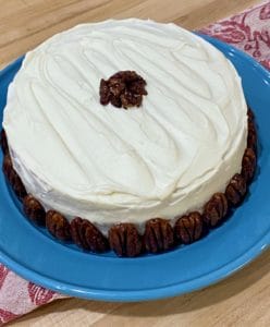 Frosted carrot cake with pecans.