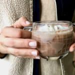 Hands holding cup of hot chocolate.
