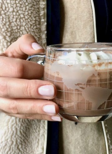 Hands holding cup of hot chocolate.