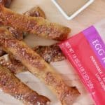 stuffed egg roll soft pretzels with product wrapper and caramel dip