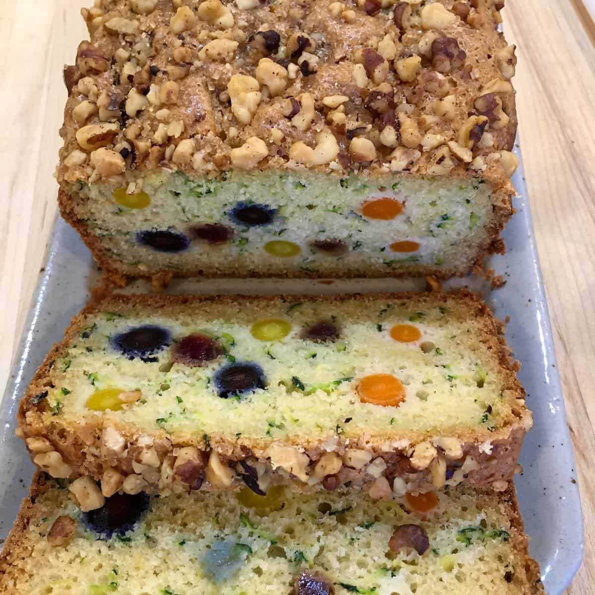 Sliced loaf exposes the pretty vegetables inside the funfetti zucchini bread.