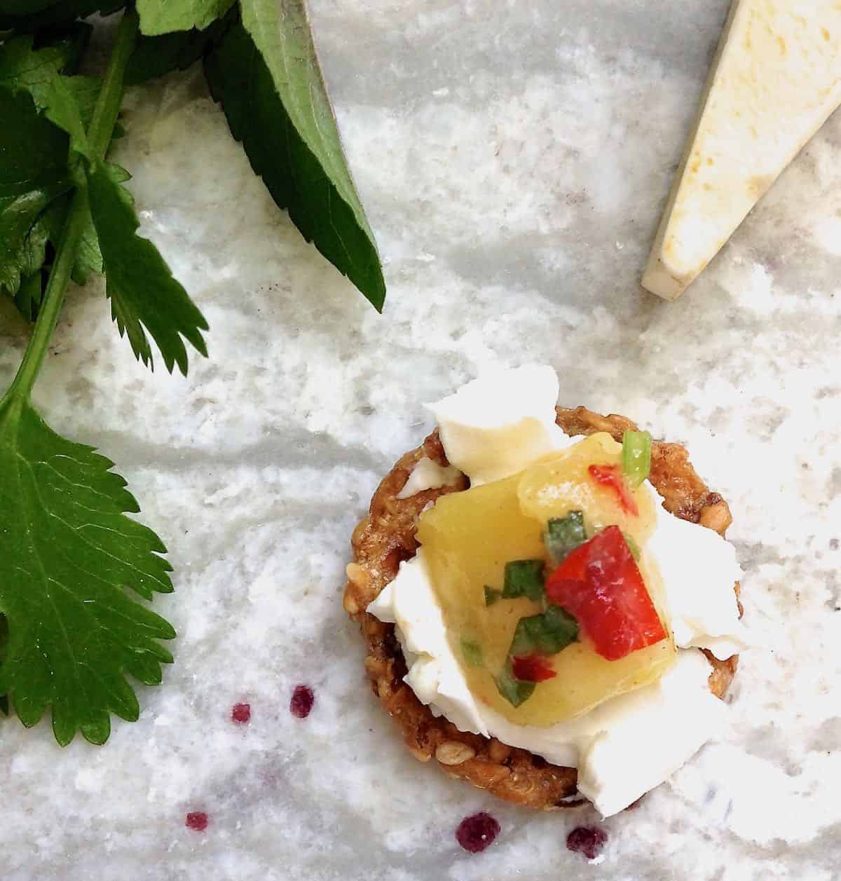 spread a cracker with your favorite soft cheese and top with some fresh Jezebel Salsa