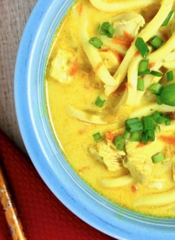 bowl of mulligatawny noodle soup with chop sticks