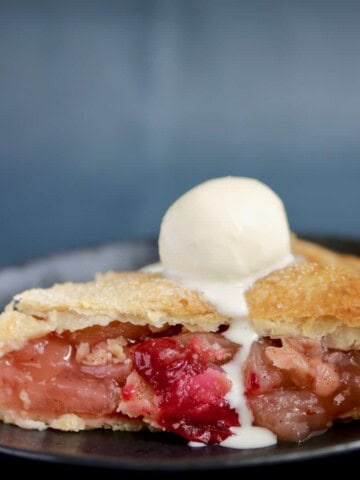 Slice of sous vide apple pie with melted ice cream.