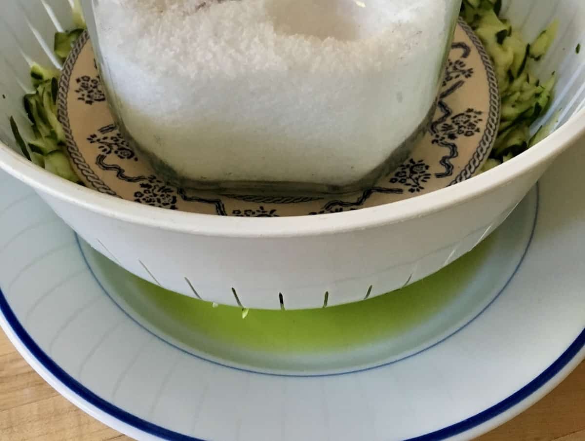 Squeezing out water from shredded zucchini.