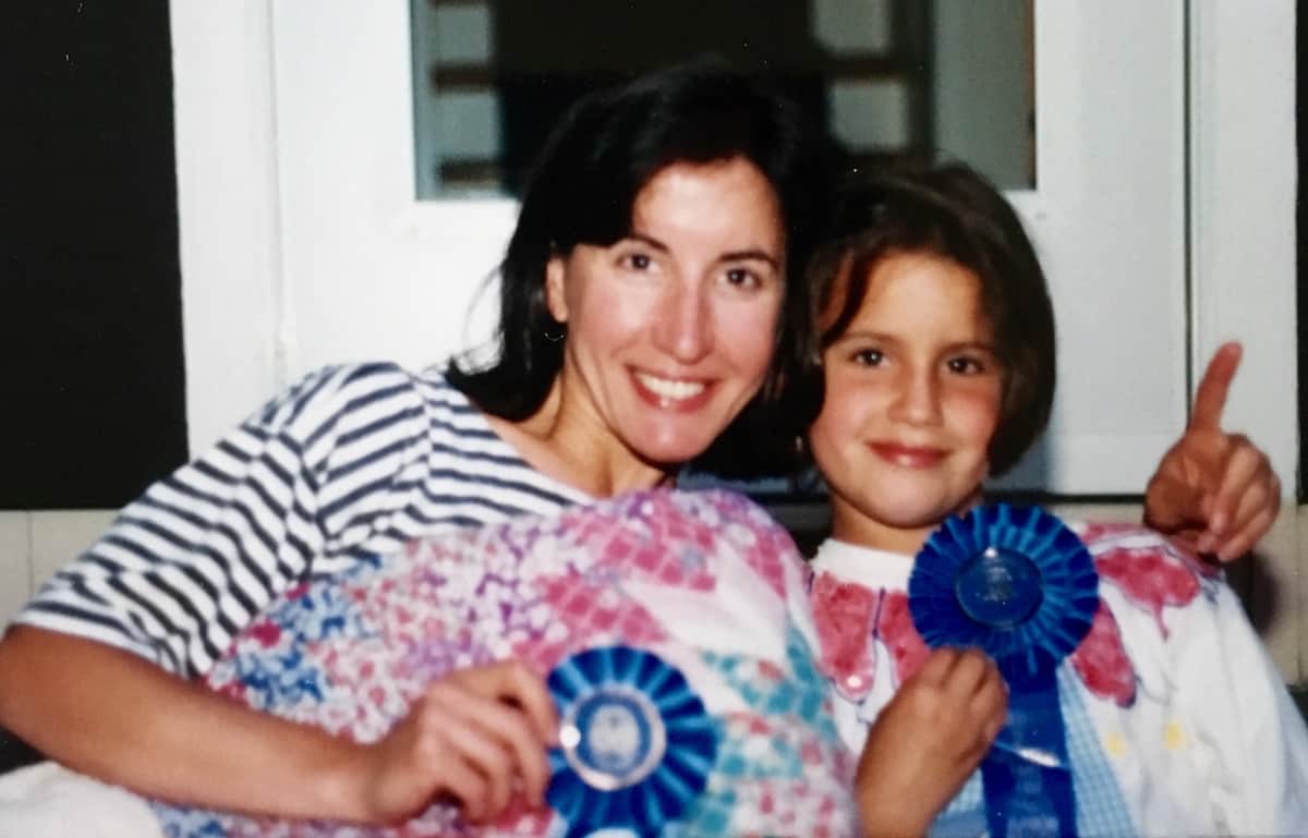 Me and my daughter with blue ribbon rosettes.