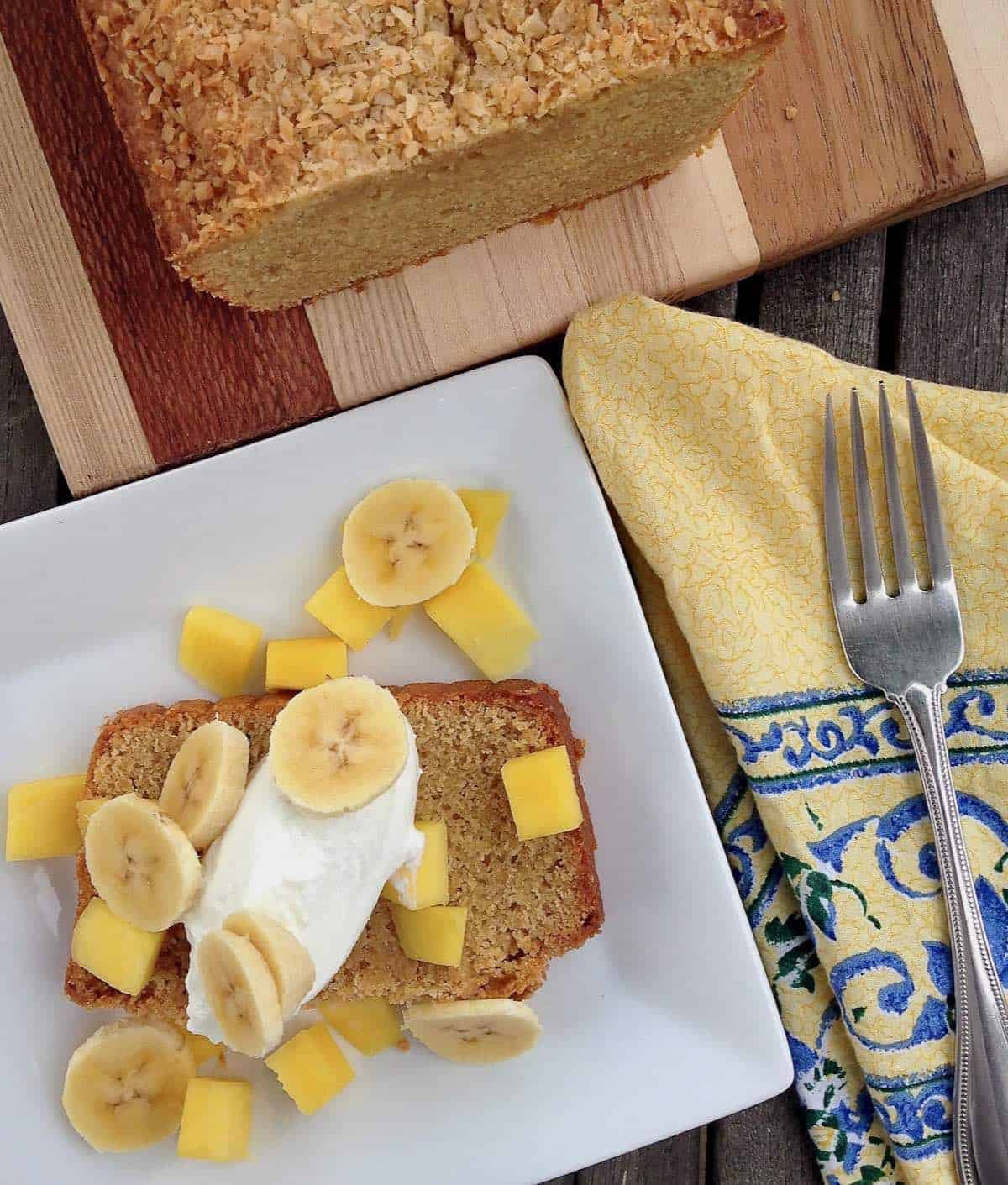 Easy coconut snack cake with banana and pineapple and yogurt on top.