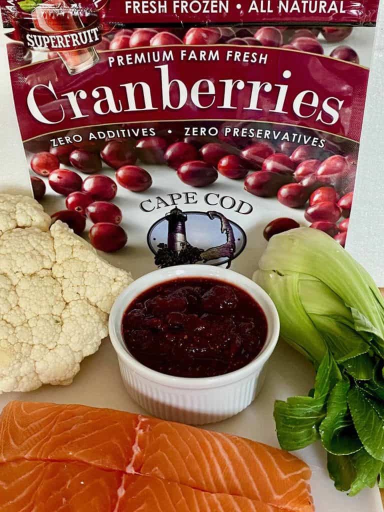 Ingredients include salmon, cauliflower, cranberry glaze and bok choy.