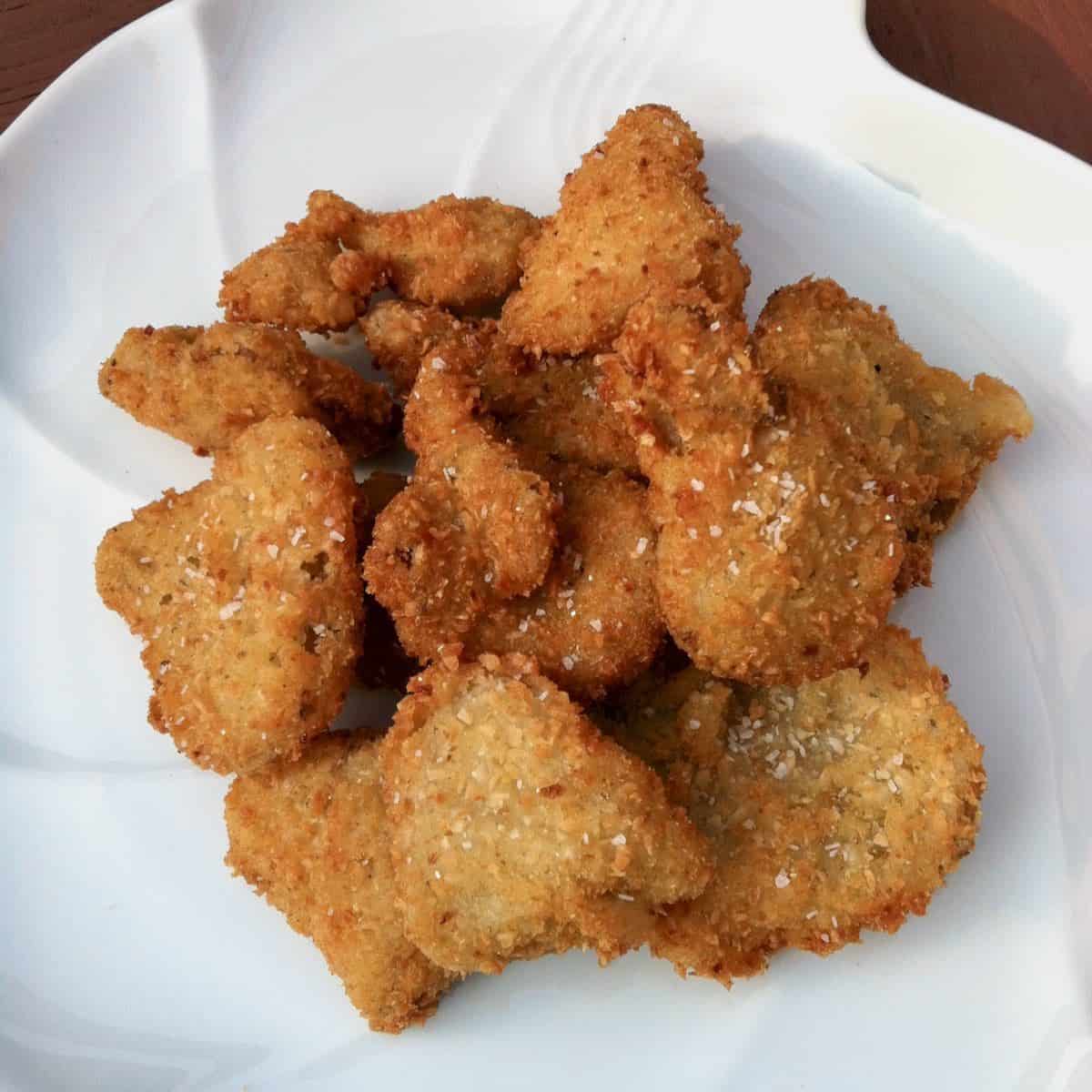 Crispy coconut oyster mushrooms on a plate.