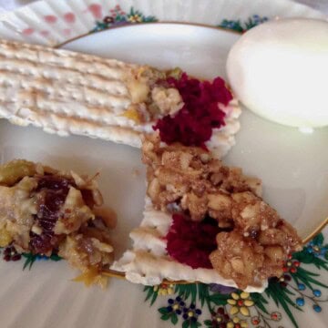 Matzoh with charsoset and beet horseradish. Notice the 10 drops of wine on the edge of the plate? It's a reminder to not feel joy for the suffering of our enemies.