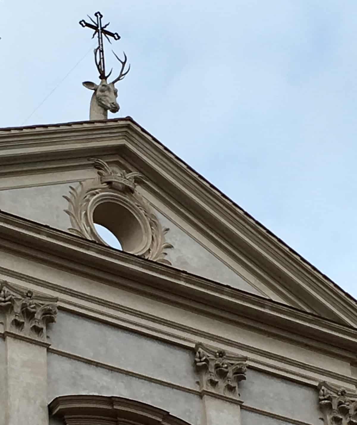 Stag statue on church.