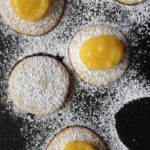 lemon curd on cookies dusted with powdered sugar