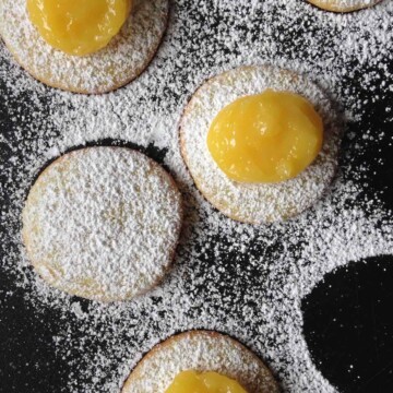 Lemon curd on cookies dusted with powdered sugar.