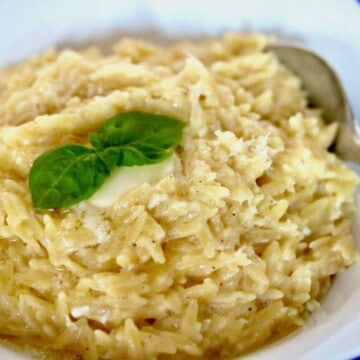Bowl of pastina topped with butter and basil.