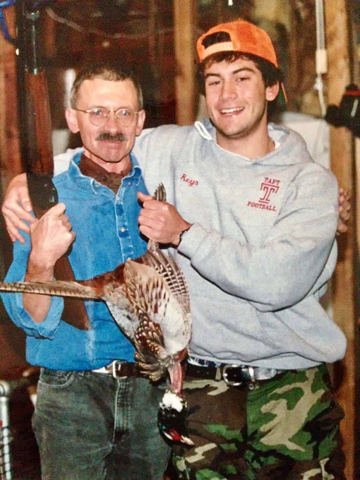 Son and husband post hunting pheasant.