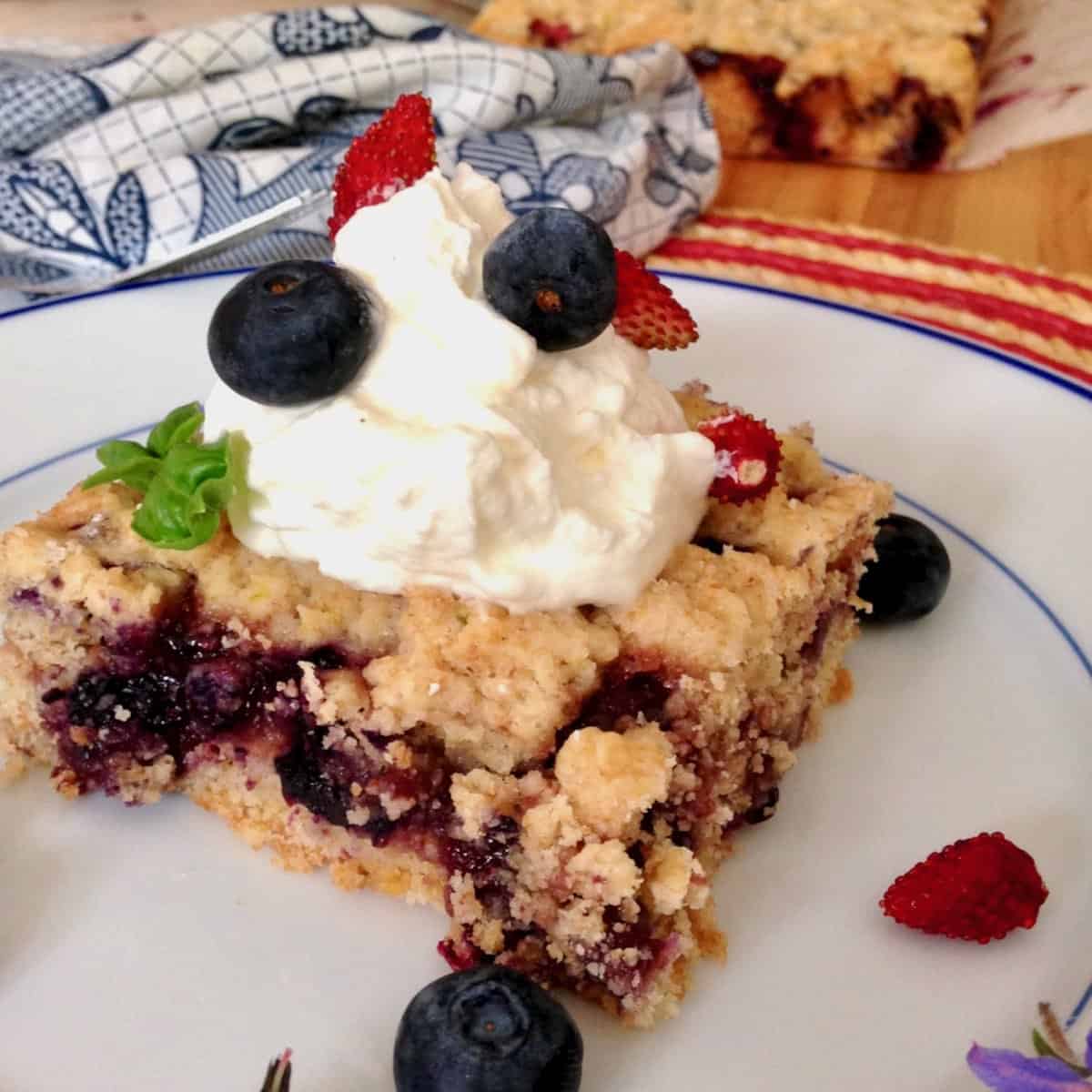 Perfect 4th of July dessert shortcake bar topped with whipped cream and berries.