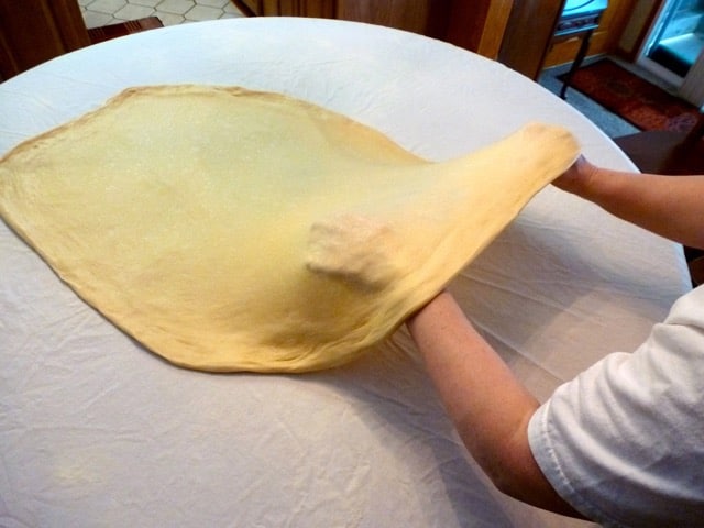 Strudel dough being stretched.