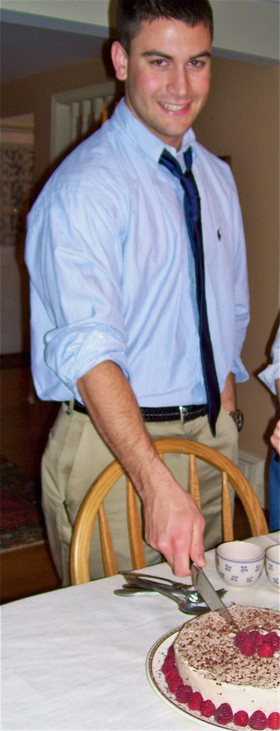 William cutting a cake.