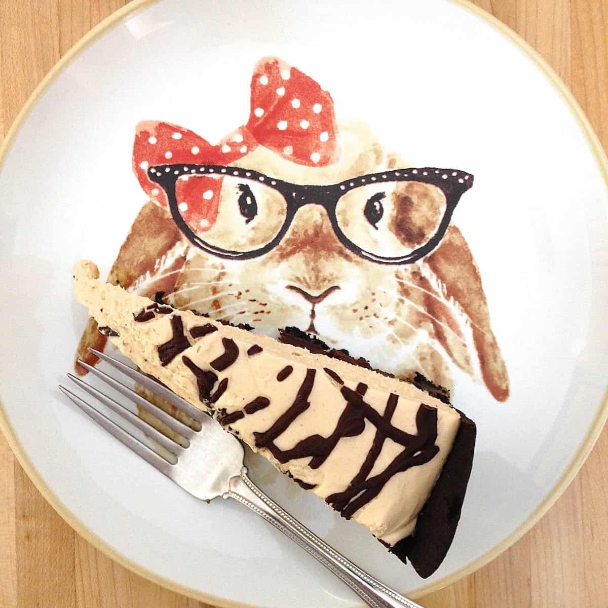 looks like me, doesn't it? slice of peanut butter turtle torte on plate painted with a lady rabbit wearing glasses