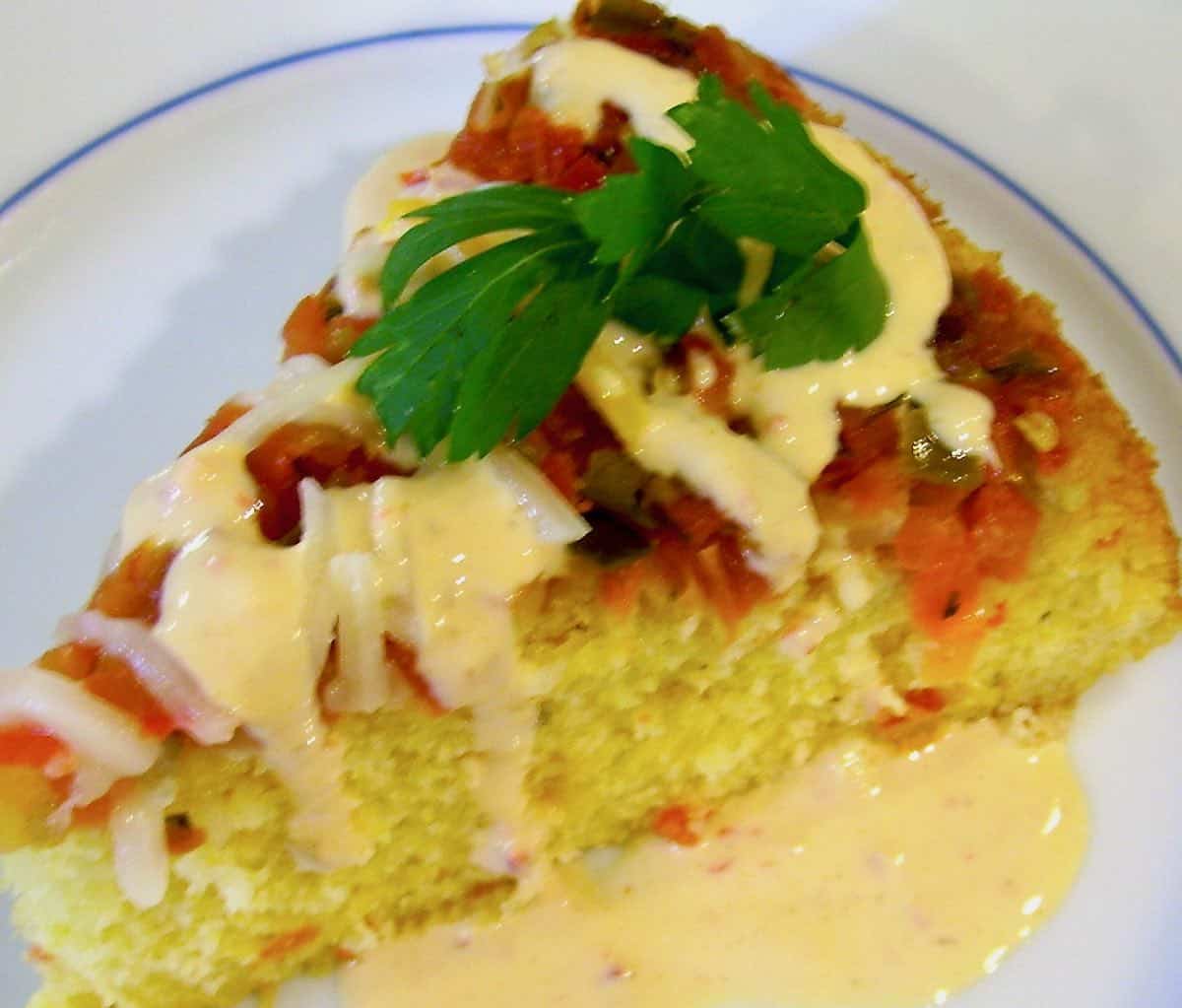 A slice of Sweet Yellow Corn Bread with garlic cream drizzle.