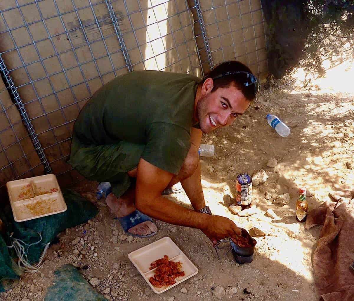 My son making dinner in the dirt of Afghanistan.