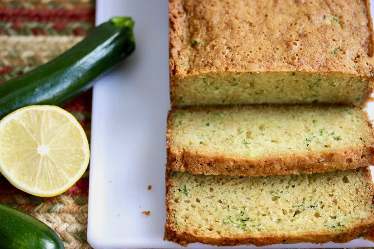 sliced zucchini bread with fresh zucchini and lemon