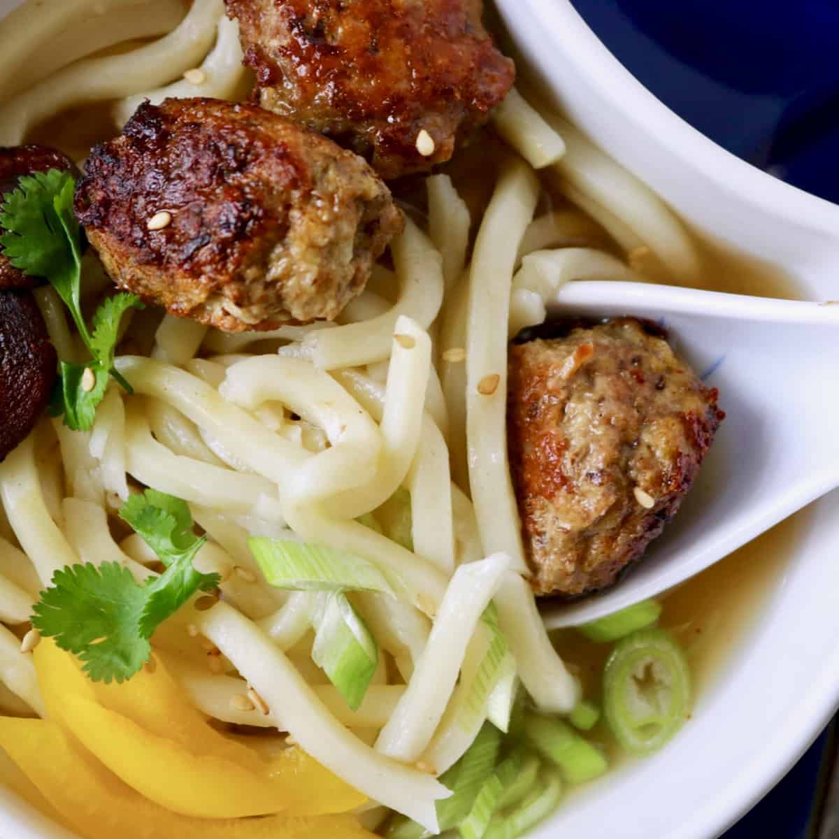 Bowl of Asian meatball noodle soup.