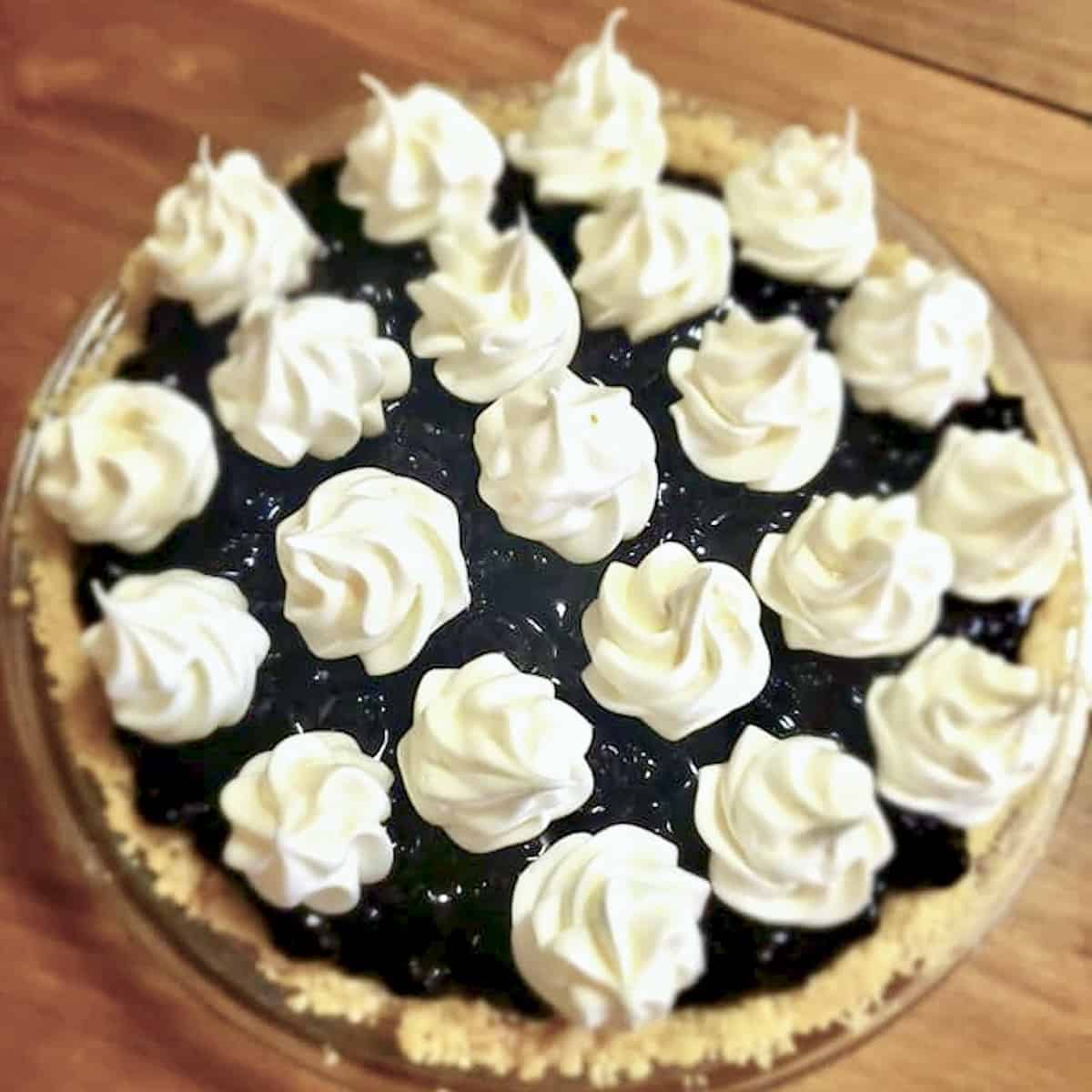 Wild berry lemon pie with meringue kisses on top.