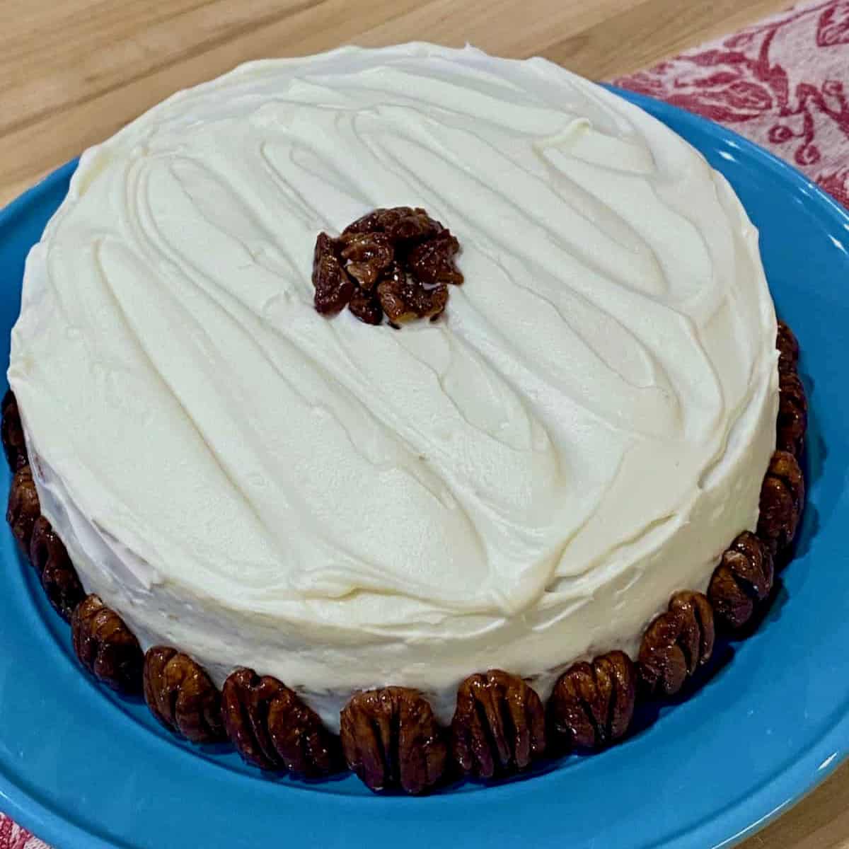 Frosted carrot cake with pecans.