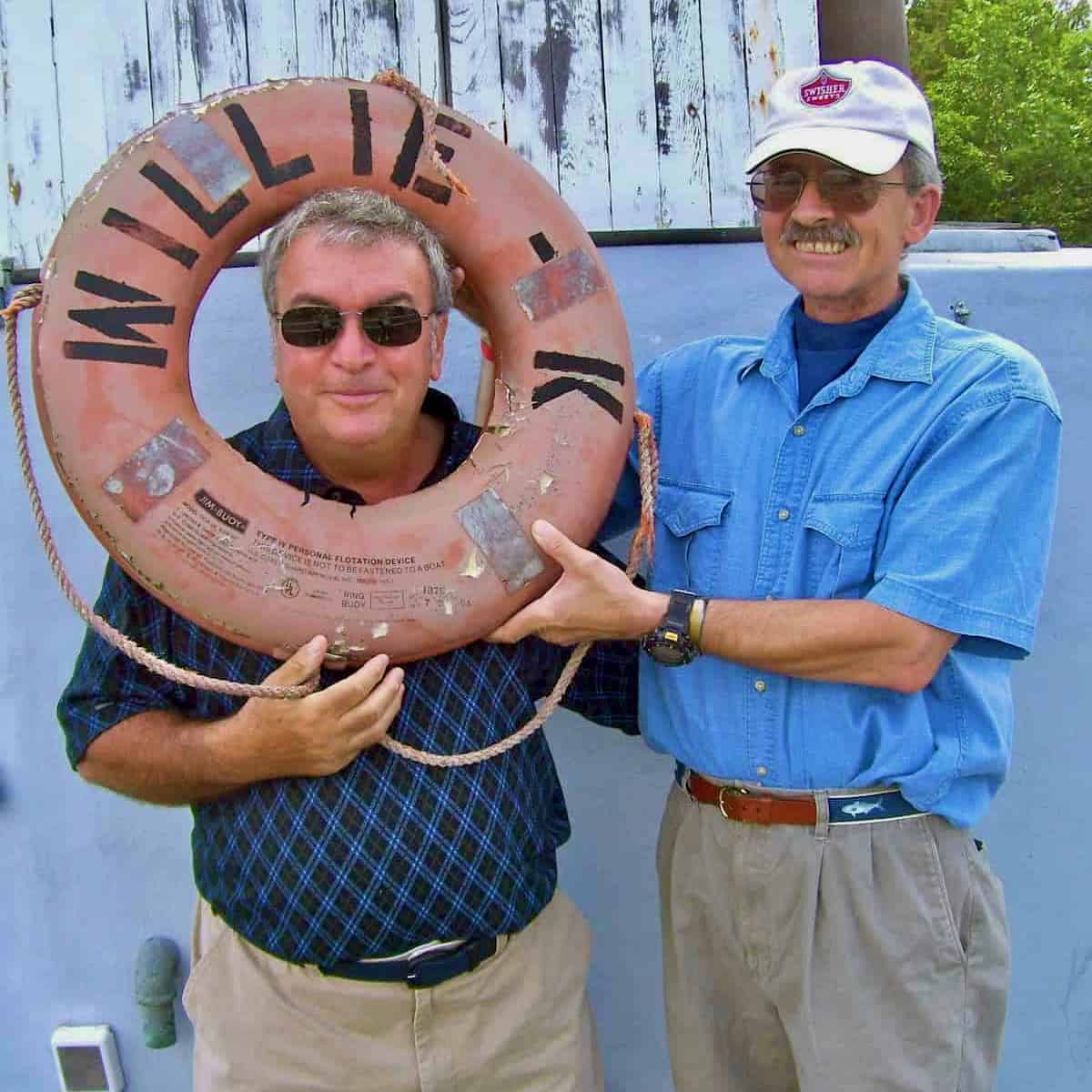 My brother and husband holding a Willie K life preserver.