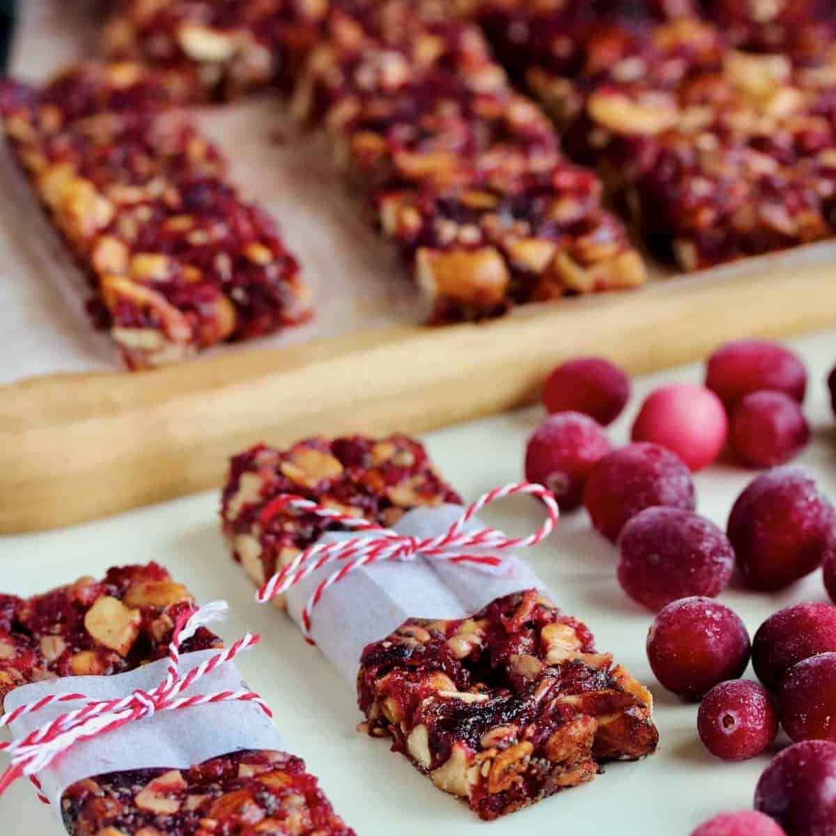 Wrapped cranberry crunch bars with fresh cranberries.