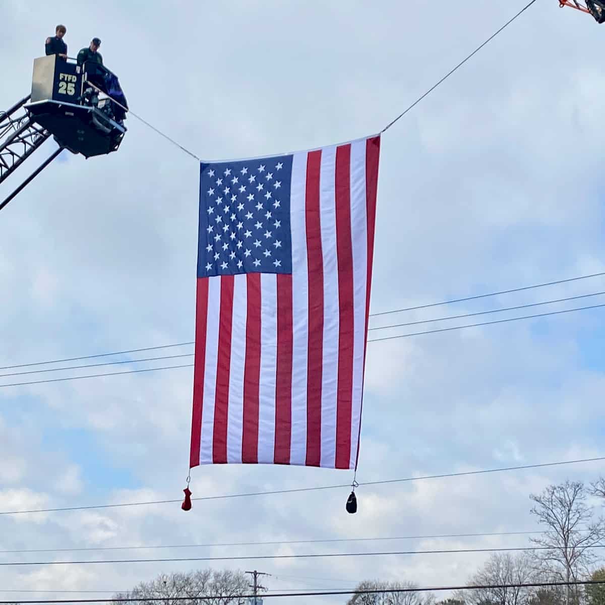 Firemen flying American flag.