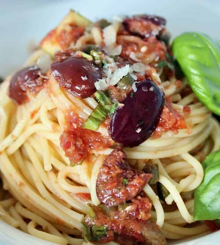 Cantina Pasta Puttanesca 2 tablespoons olive oil 3 oil packed anchovies ½ cup pitted green olives, halved ½ cup pitted kalamata olives, halved 2 tablespoons capers, rinsed and drained 1 small zucchini diced into bite-size pieces 1 (12 oz.) container Sam’s Fresh Cantina Style Salsa 8 oz. dried Spaghetti 2 tablespoons chopped fresh flat leaf parsley 2 tablespoons thinly sliced fresh basil Freshly grated parmesan cheese or crumbled feta Heat olive oil in large skillet over medium-low heat. Add anchovies; cook 1 minute. Stir in olives, capers and zucchini breaking up the anchovies. Cook 2 minutes or until olives are just warmed through. Stir in salsa. Increase heat and bring mixture just to a boil. Reduce heat and simmer gently, uncovered, while cooking pasta. Cook pasta in boiling salted water for 8 to 10 minutes or to just al dente (slightly chewy). Drain pasta reserving ½ cup of pasta water. Add pasta and fresh herbs to simmering sauce; toss gently to coat. Add some of the reserved pasta water if the sauce seems too thick. Serv