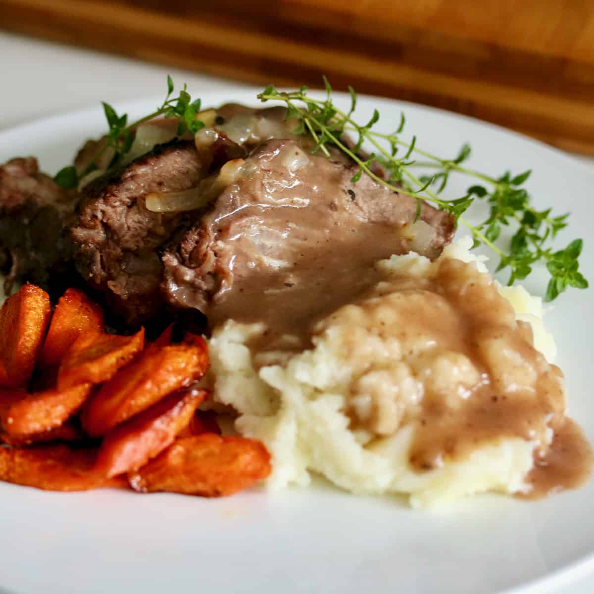 Sous vide pot roast with gravy, mashed potatoes and carrots.