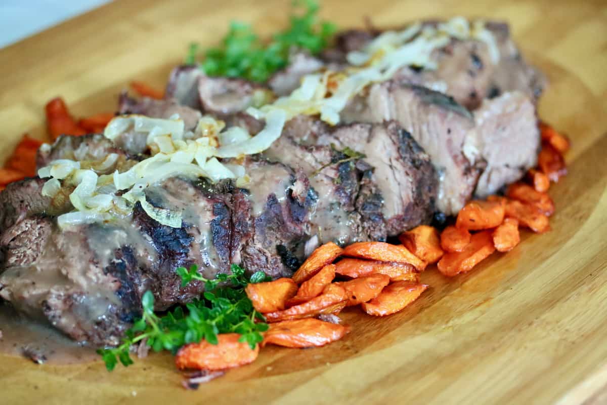 Sunday supper includes sliced sous vide pot roast, roasted carrots, frizzled onions with lemon thyme garnish.
