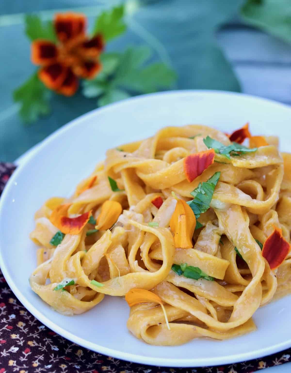 pumpkin spice pasta with marigolds and herbs