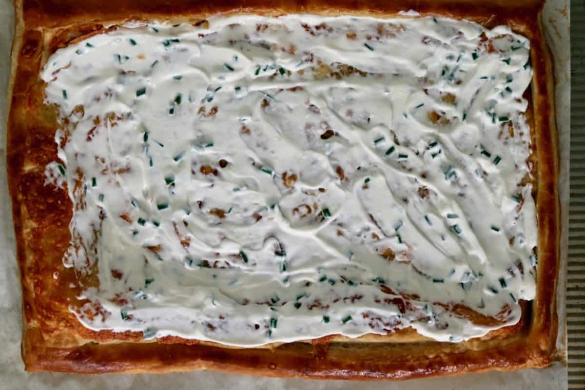 Labne and chives spread over baked pastry.