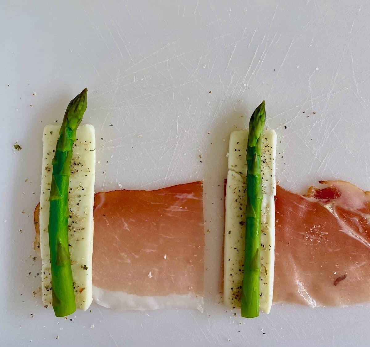 Rolling the paneer, proscuitto & asparagus tapas.