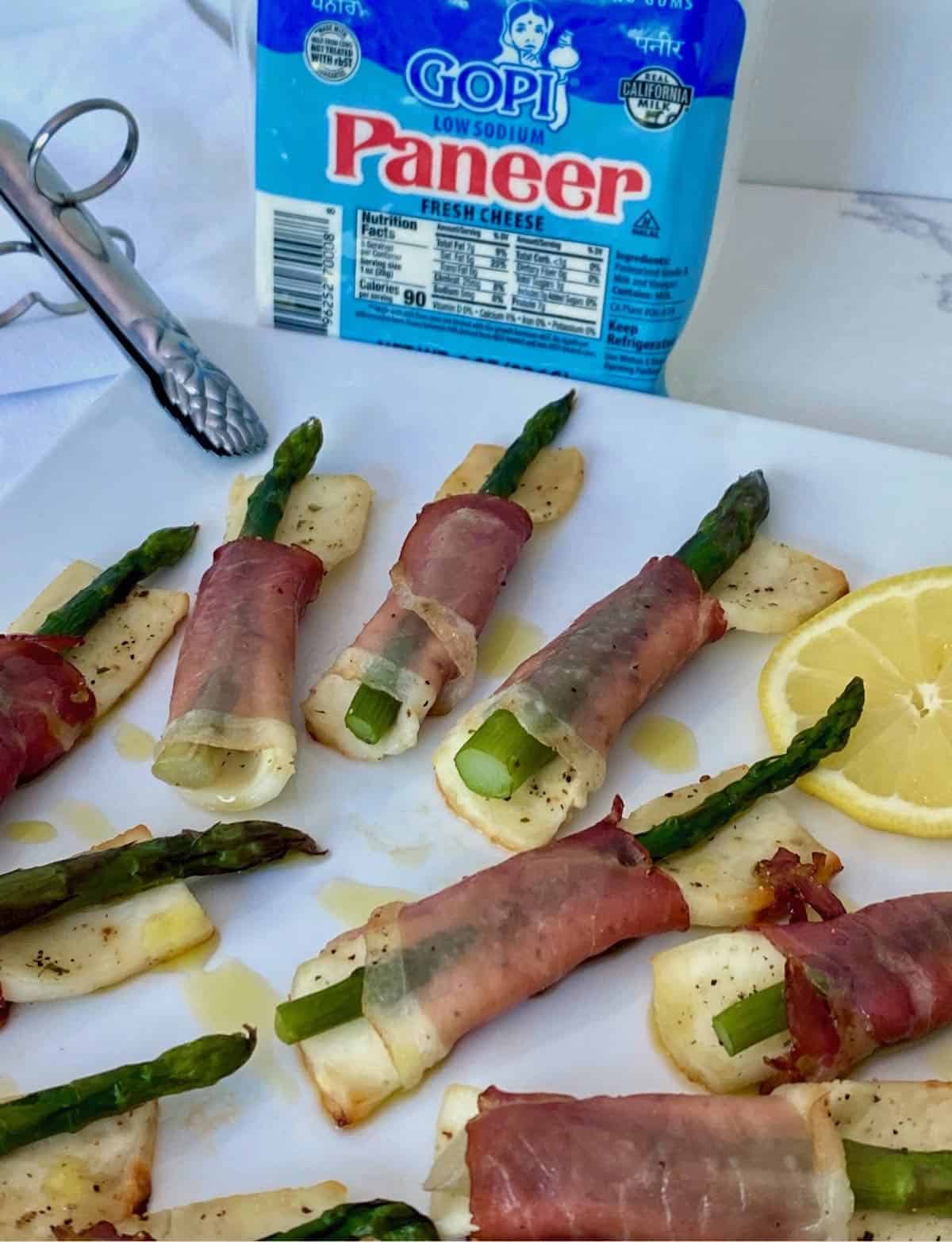 Plate of paneer, prosciutto & asparagus tapas.